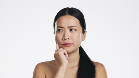 Skincare,-thinking-and-Asian-woman-in-studio