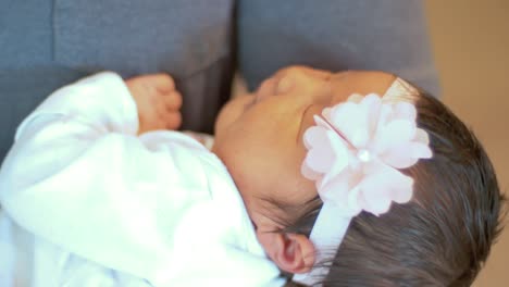 a father rocks his sleeping newborn baby in his arms