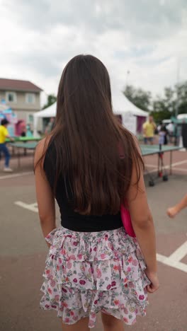 woman in a floral skirt at an outdoor event