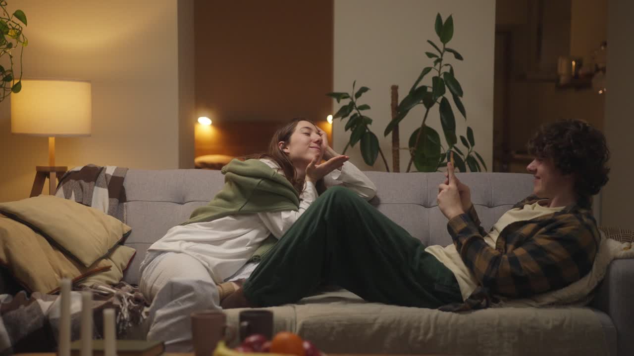 Affectionate Couple Relaxing on Sofa at Home