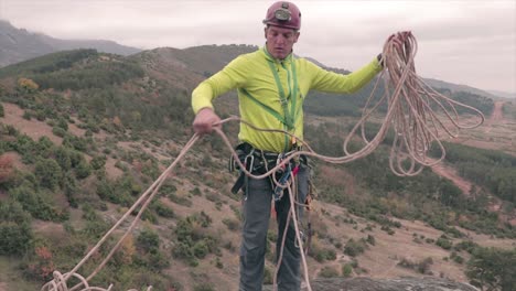 climber collecting a rope preparing it for climbing