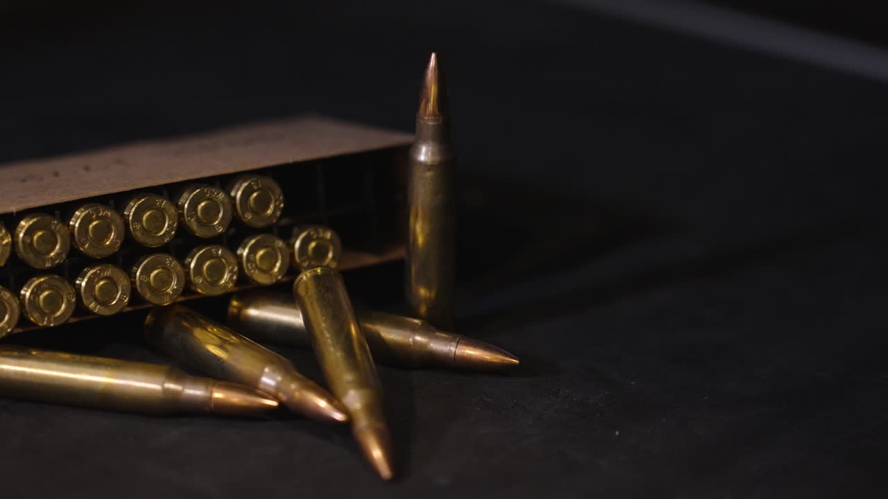 Panning right across box of ammo in 5.56 Nato.
