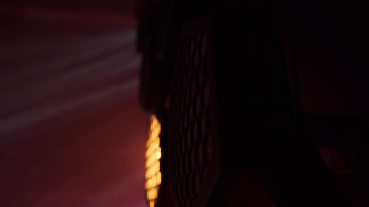 Party and disco concept, blinking warm light soffits. Stock footage. Close up of orange flashing spotlights on a stage of night club during concert