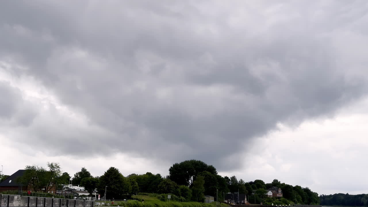 Dark Clouds Loom Over a Coastal Town on the North Sea, Threatening to Unleash Nature's Fury on the Tranquil Landscape Gathering Storm