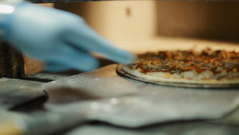 step to making pizza by chef. chef giving finishing touch to pizza in kitchen