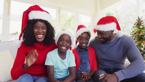 african american family smiling and waving looking at the camera