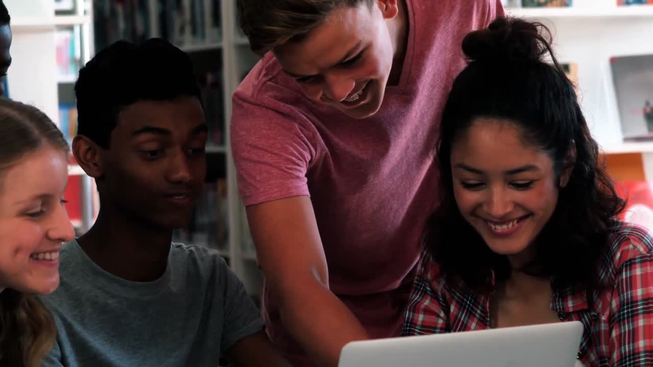 Students using laptop in classroom