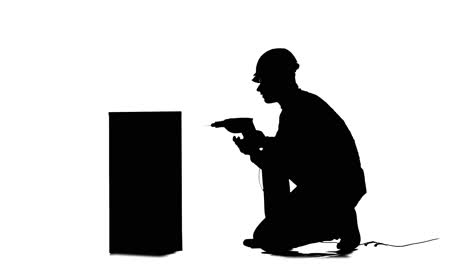 worker drilling into box