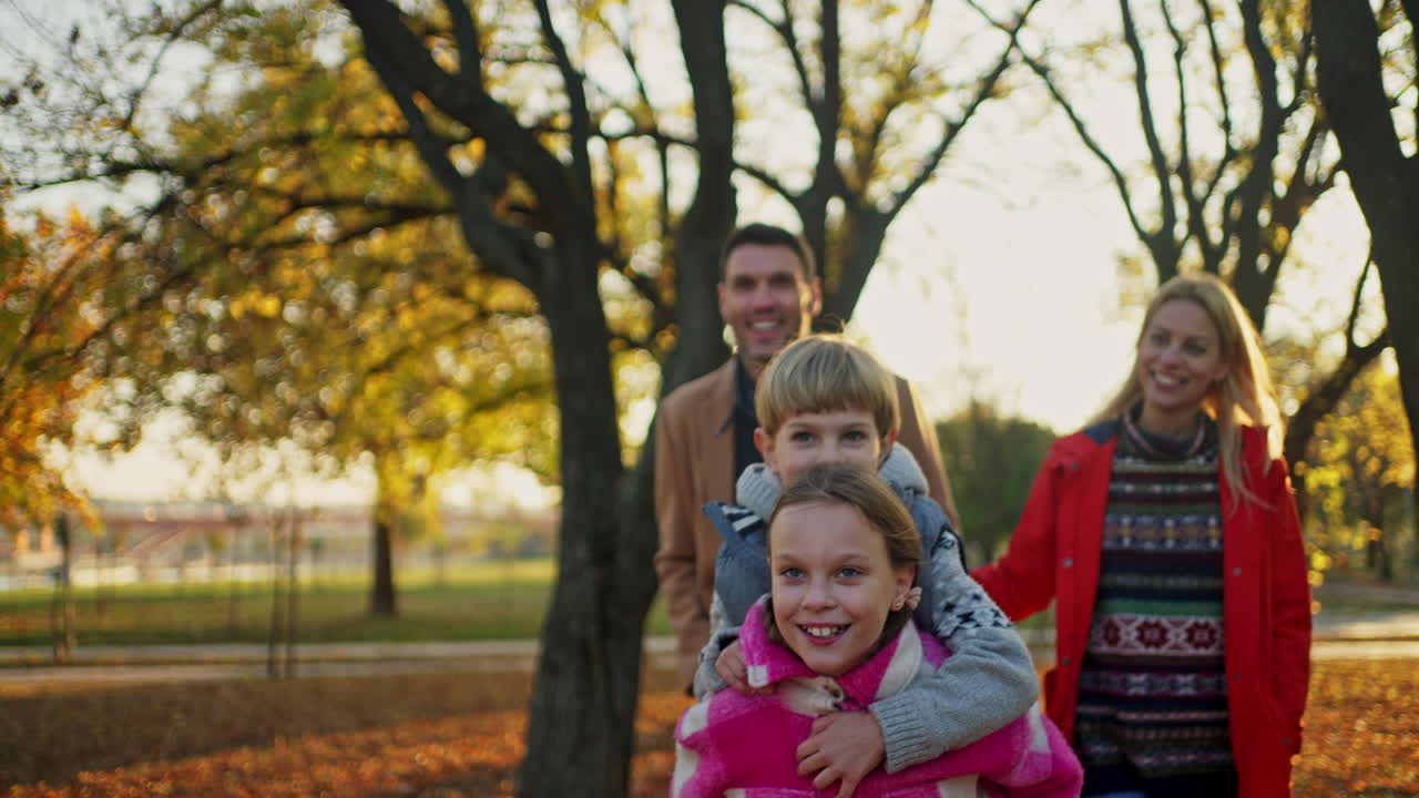 Family having fun in autumn park