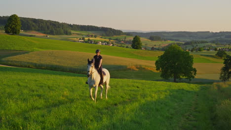 a woman gallops on a white horse