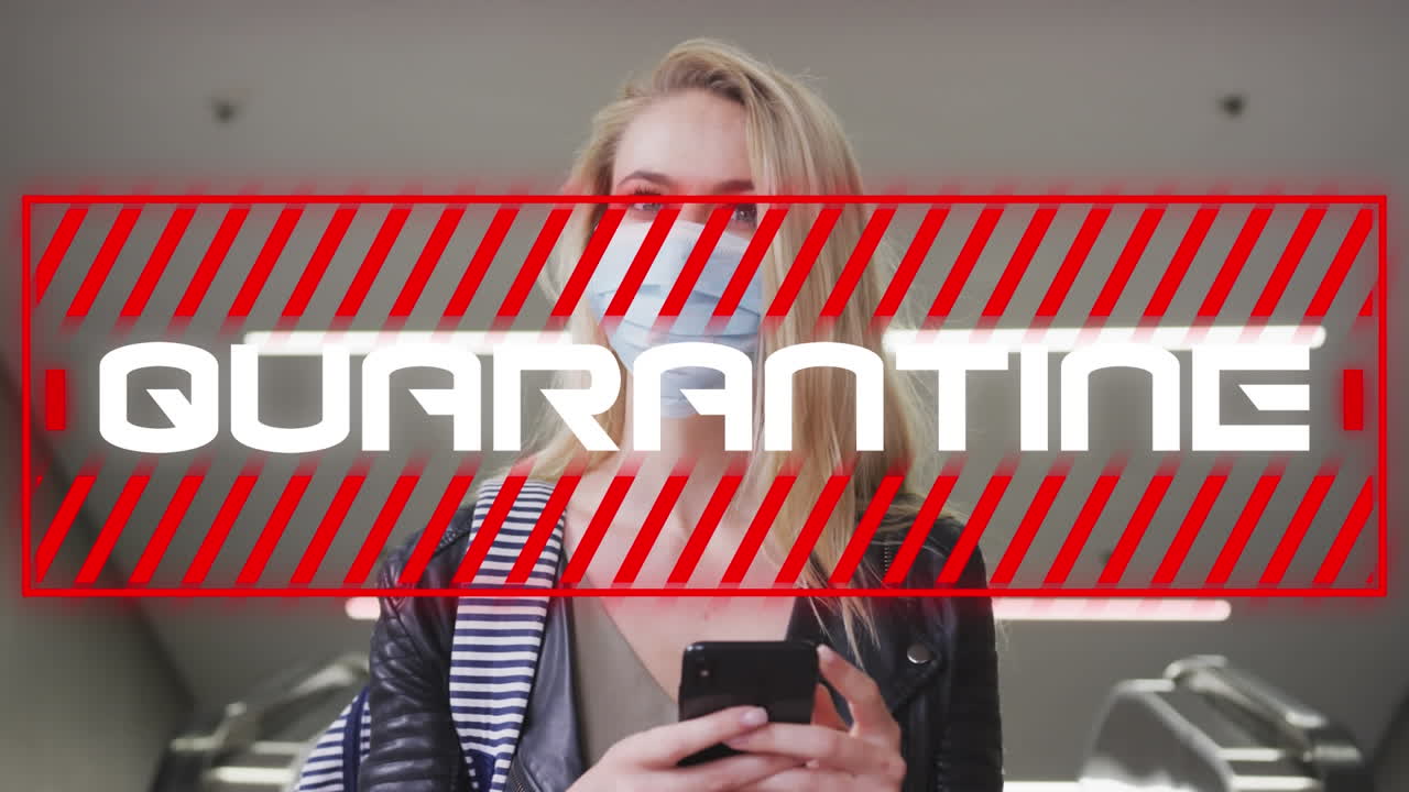 Animation of text quarantine, over woman in face mask using smartphone in city street