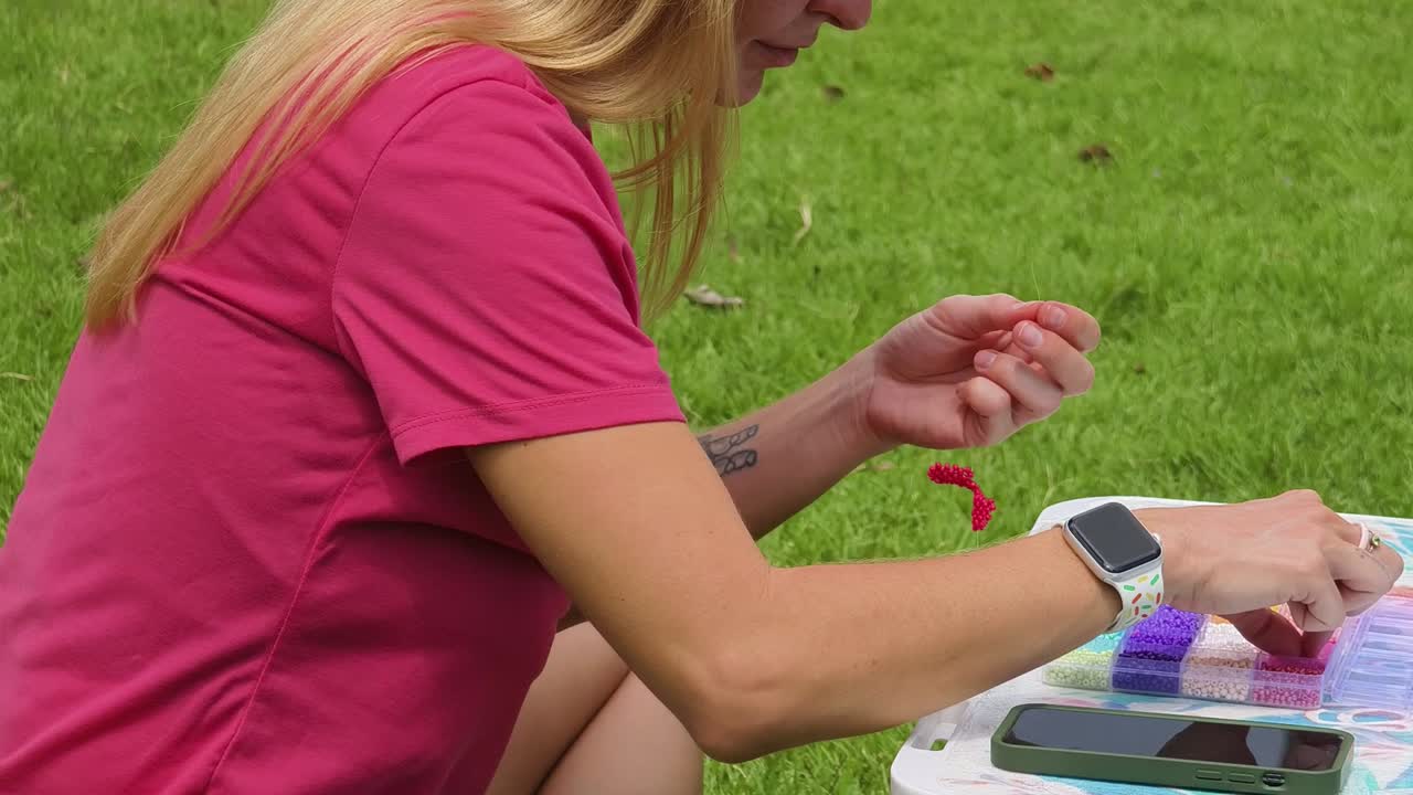 Woman Beading Outdoors