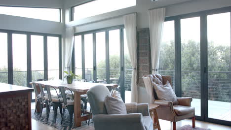 general view of living room with armchairs, table and windows, slow motion