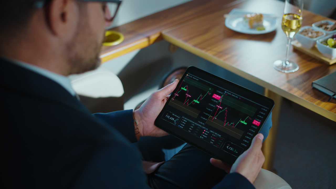 Businessman Analyzing Stock Market Data on Tablet