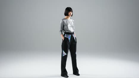 a stylish model showcases modern fashion with a focus on innovative design and elegant silhouettes in a minimalist studio environment