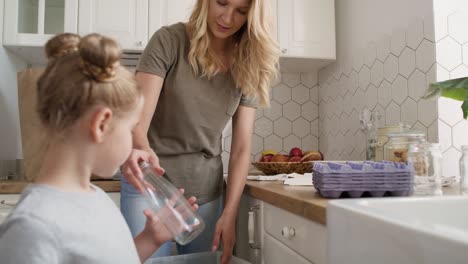 video of mother and daughter separating recycling material at home