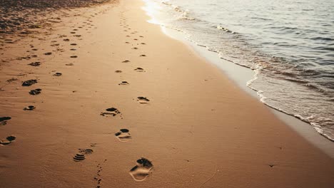 footprints in the sand at sunset: a serene beach scene capturing tranquility and reflection as waves gently lapping at the shore emphasize nature's beauty