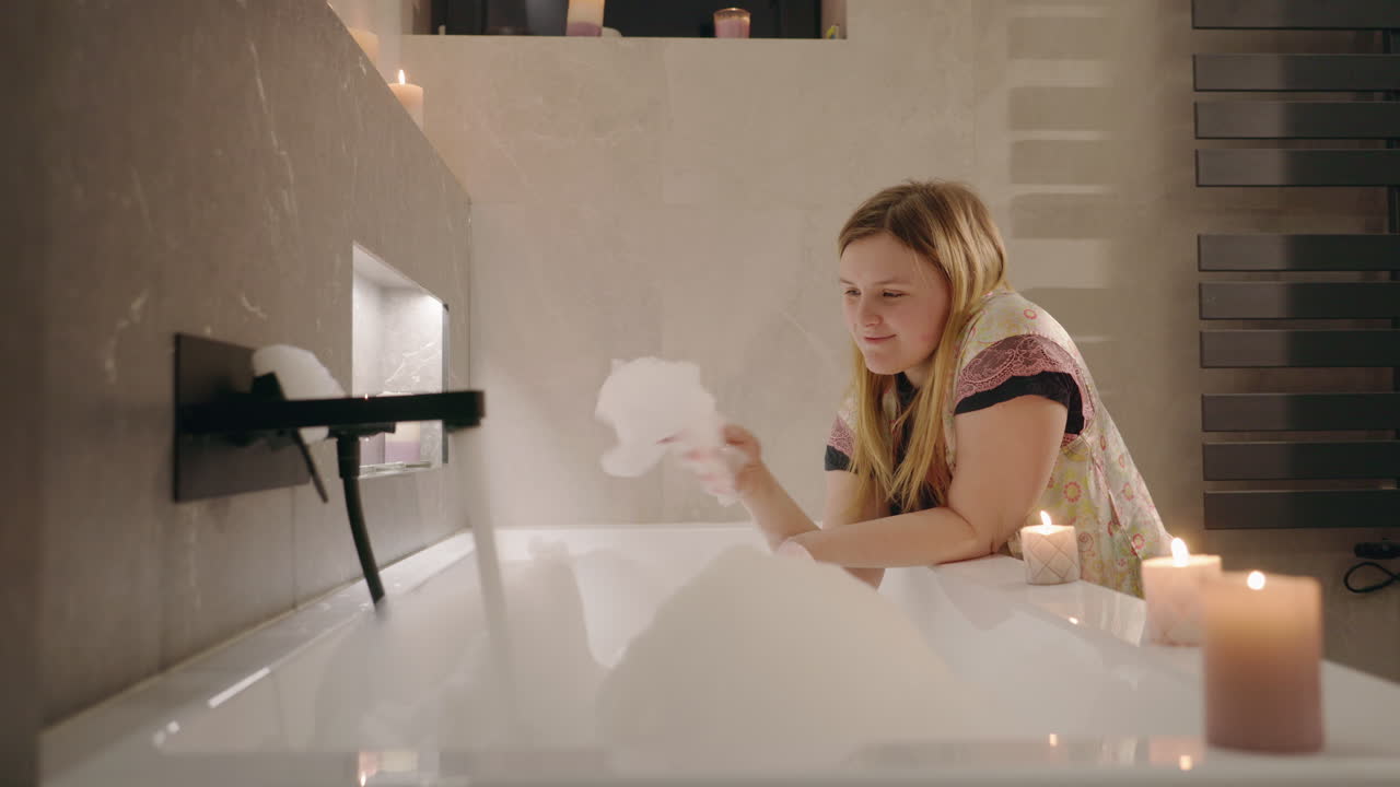 Woman enjoying a bubble bath in a modern bathroom