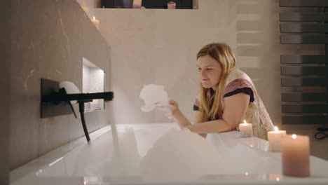 woman enjoying a bubble bath in a modern bathroom