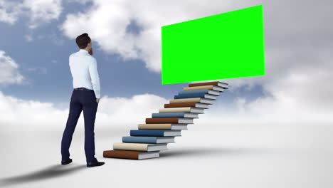 businessman looking at green screen in the cloudy sky