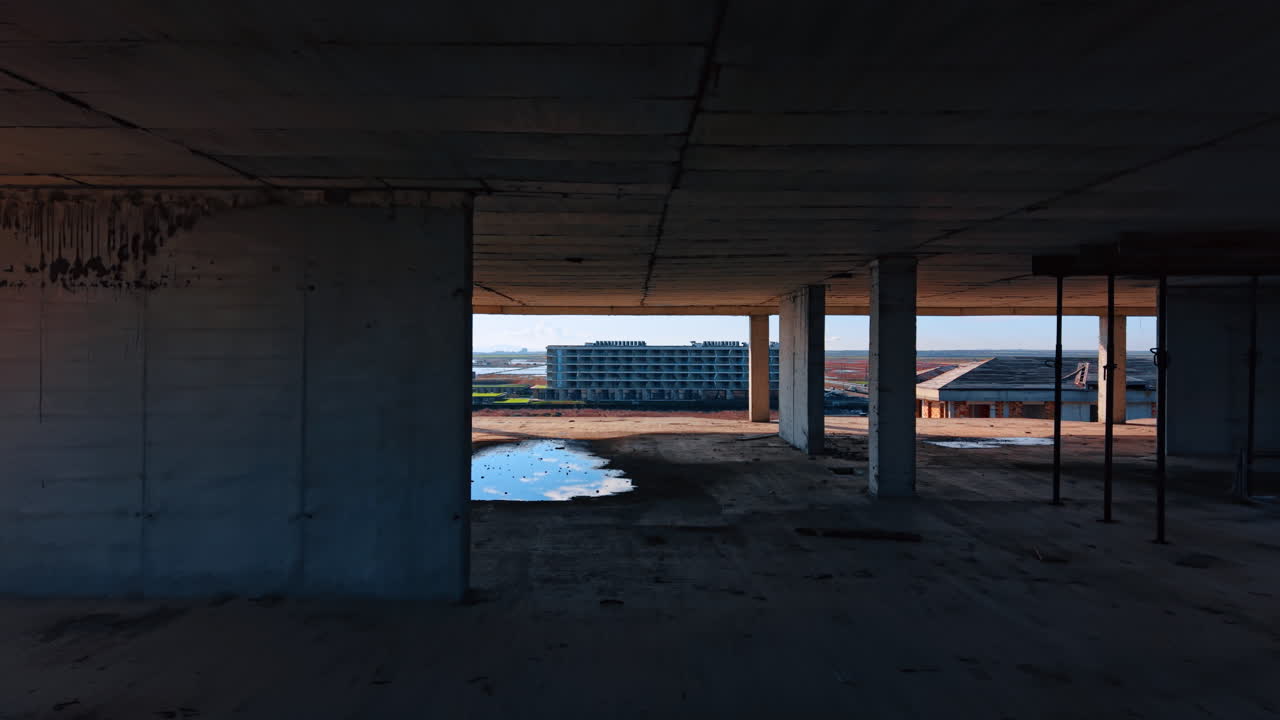 Volando attraverso il pavimento della costruzione abbandonata. Alcuni edifici sullo sfondo del bellissimo paesaggio marino.