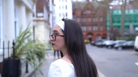 Beautiful-young-woman-walking-and-seen-from-behind-in-Soho,-London,-medium-shot