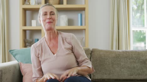 Portrait-of-happy-senior-diverse-couple-wearing-shirts-and-making-video-call-in-living-room