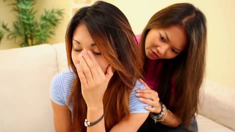 Girl-comforting-sister-on-couch