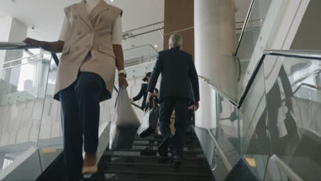 business people walking upstairs in modern office building