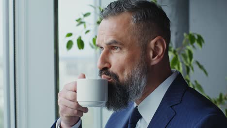 mature businessman looking out a window