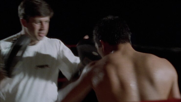 Two boxers fighting in a boxing ring 3