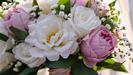close-up video of a bridal bouquet with white and pink roses, captured from a low angle