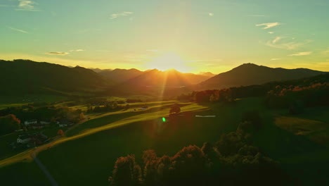 aerial view of a beautiful rural town and fields, colorful fall sunset in austria