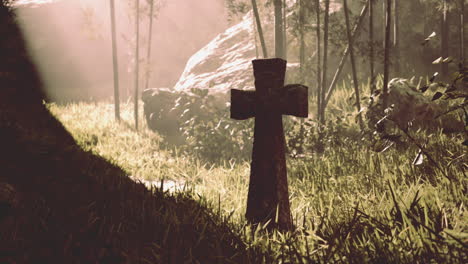 a stone cross in a misty forest