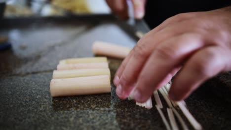 Chef-slicing-acai-heart-of-palm-plants-harvested-from-eco-friendly-farms-in-the-Amazon-rainforest---isolated-close-up