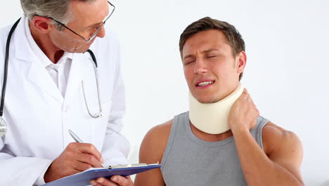 doctor checking sportsman in neck brace