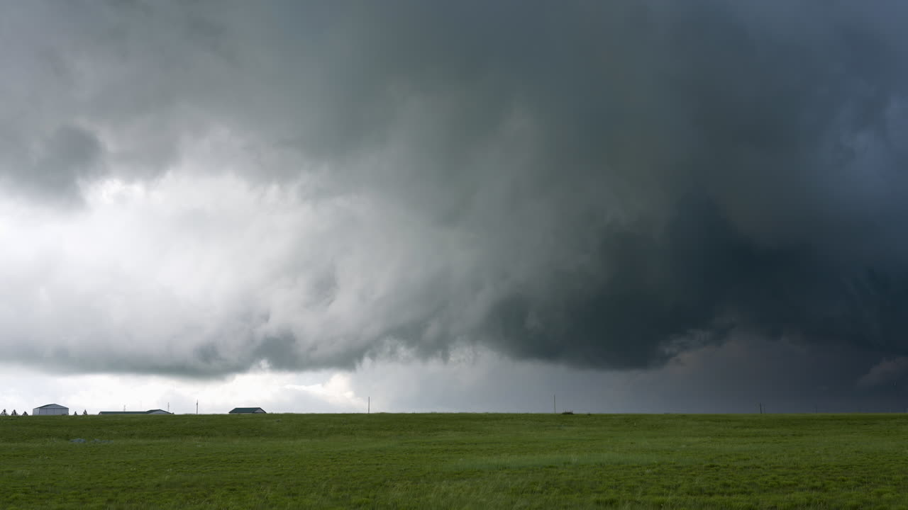 Storm Clouds Moving Across Sky Above Hills And Farm Houses