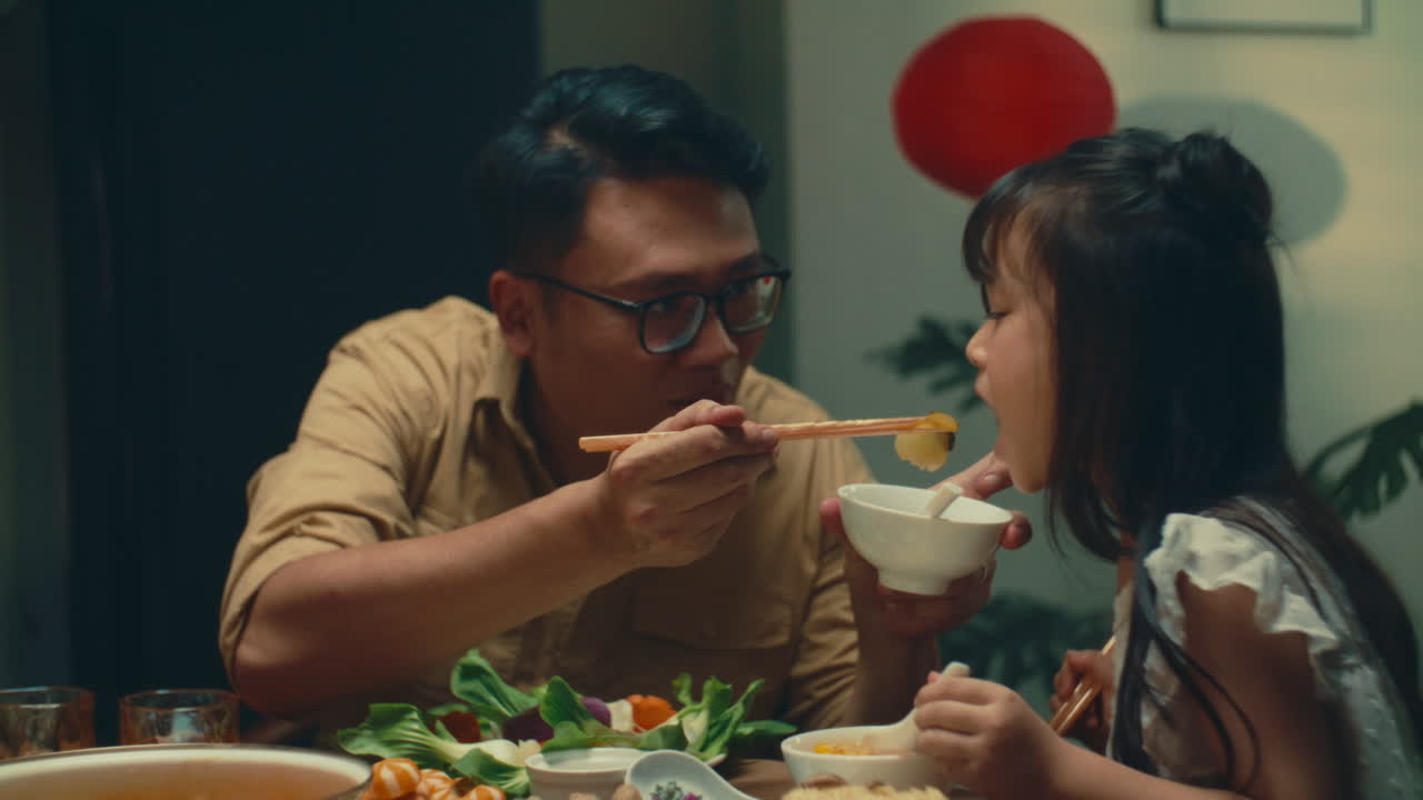Father and daughter enjoying a meal together with warmth and happiness at home
