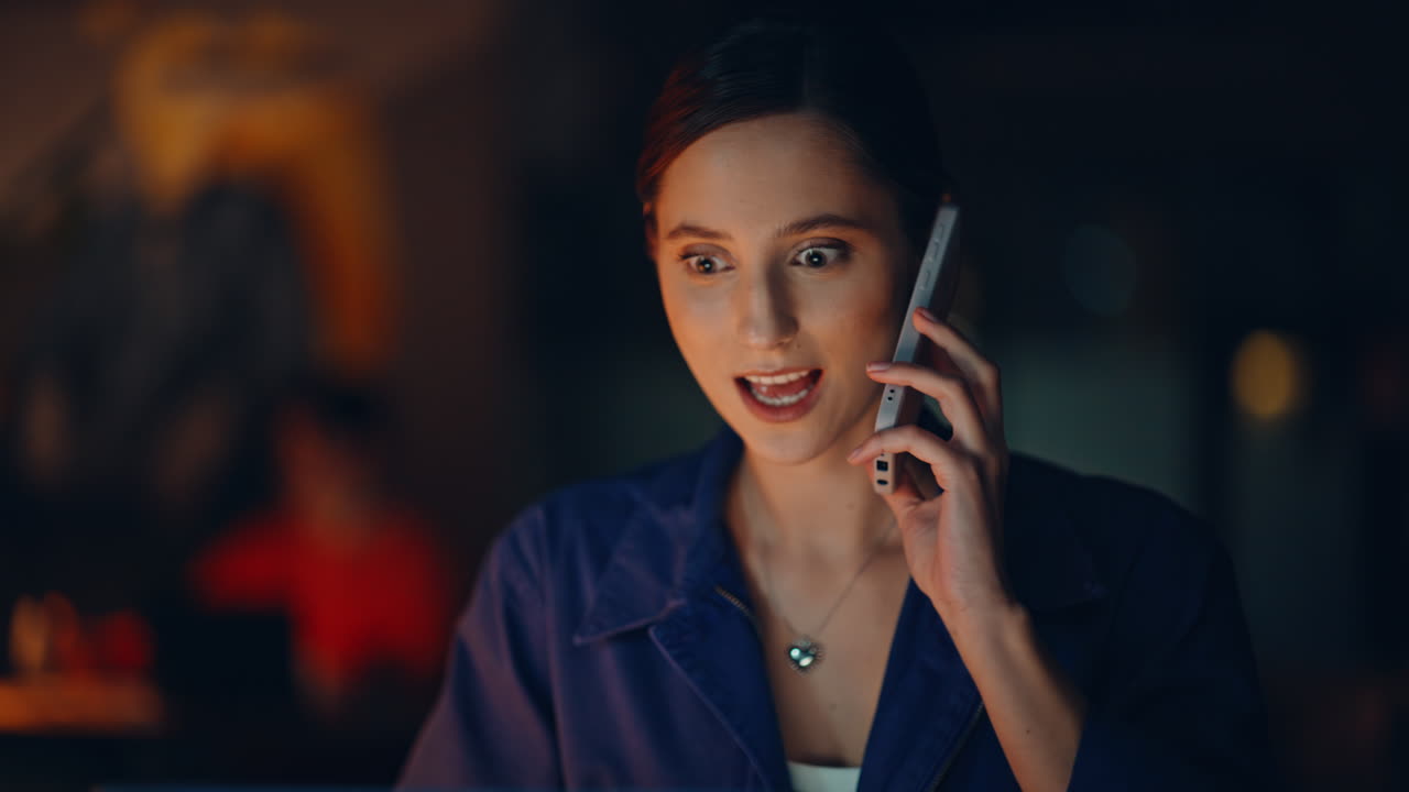 Happy student calling dark apartment workplace closeup. Smiling woman freelancer