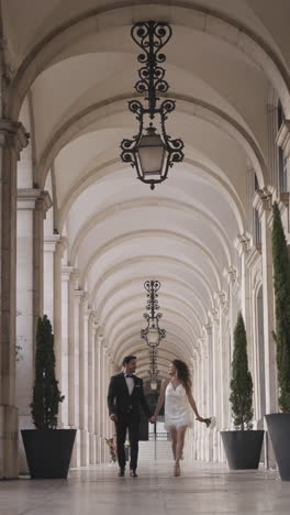 couple walking through an archway on their wedding day