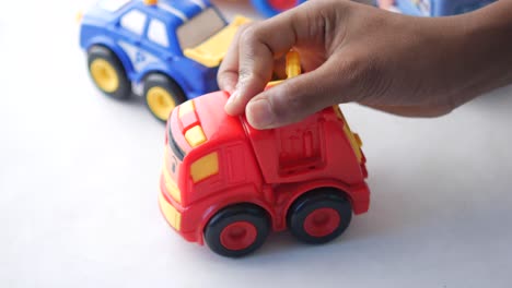 child playing with toy cars and truck