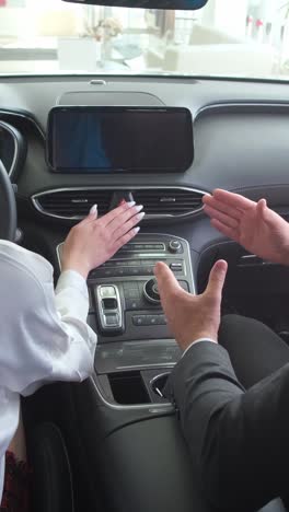 a man and a woman are sitting in a luxury car and talking to each other a man and a woman are sitting in a luxury car and talking to each other they are gesturing while talking buying a new car