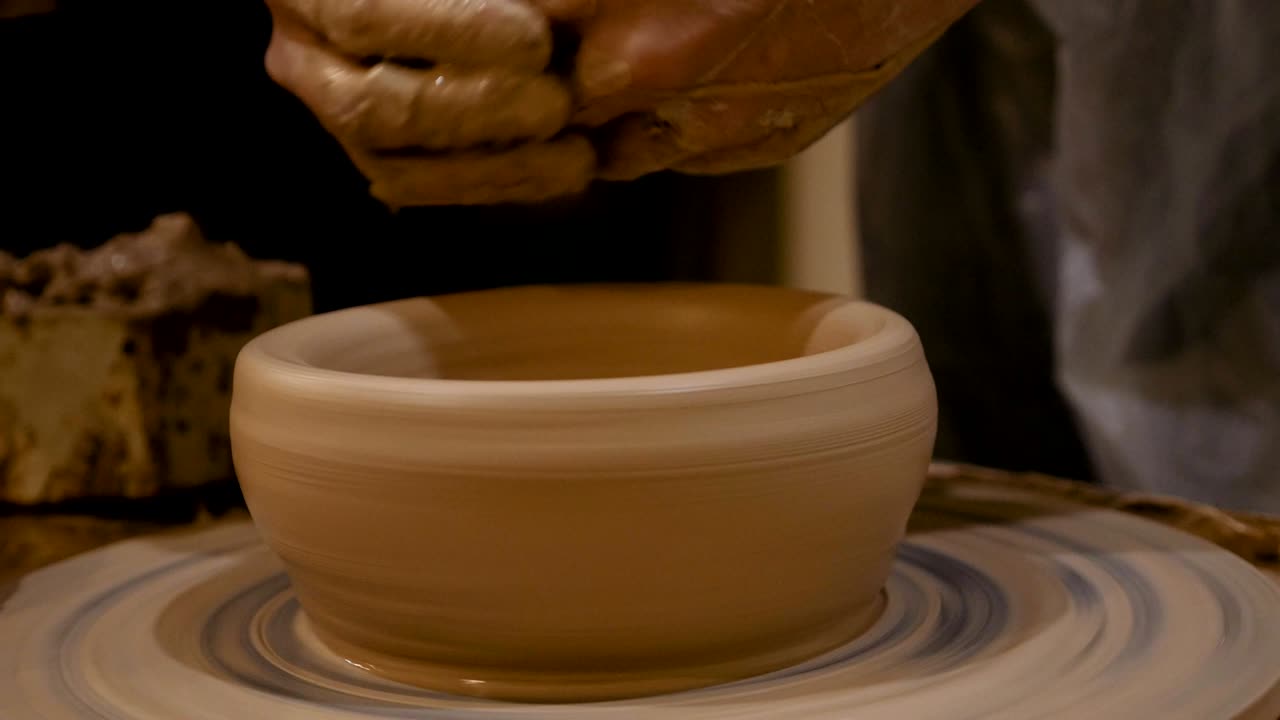 el alfarero está haciendo una olla de arcilla en la rueda del alfarero