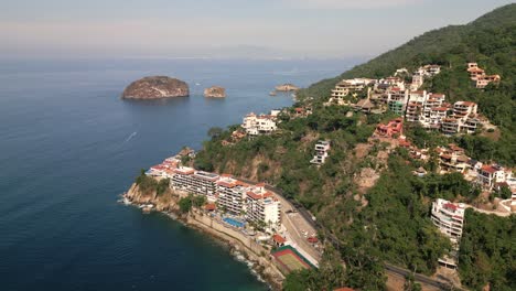 mexican fishermen's village houses above hill next to ocean, mismaloya aerial drone landscape