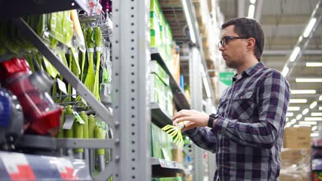 man shopping for cleaning supplies in a supermarket