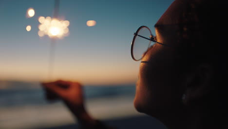 portrait teenage girl holding sparkler on beach at sunset celebrating new years eve young woman enjoying  independence day celebration 4th of july