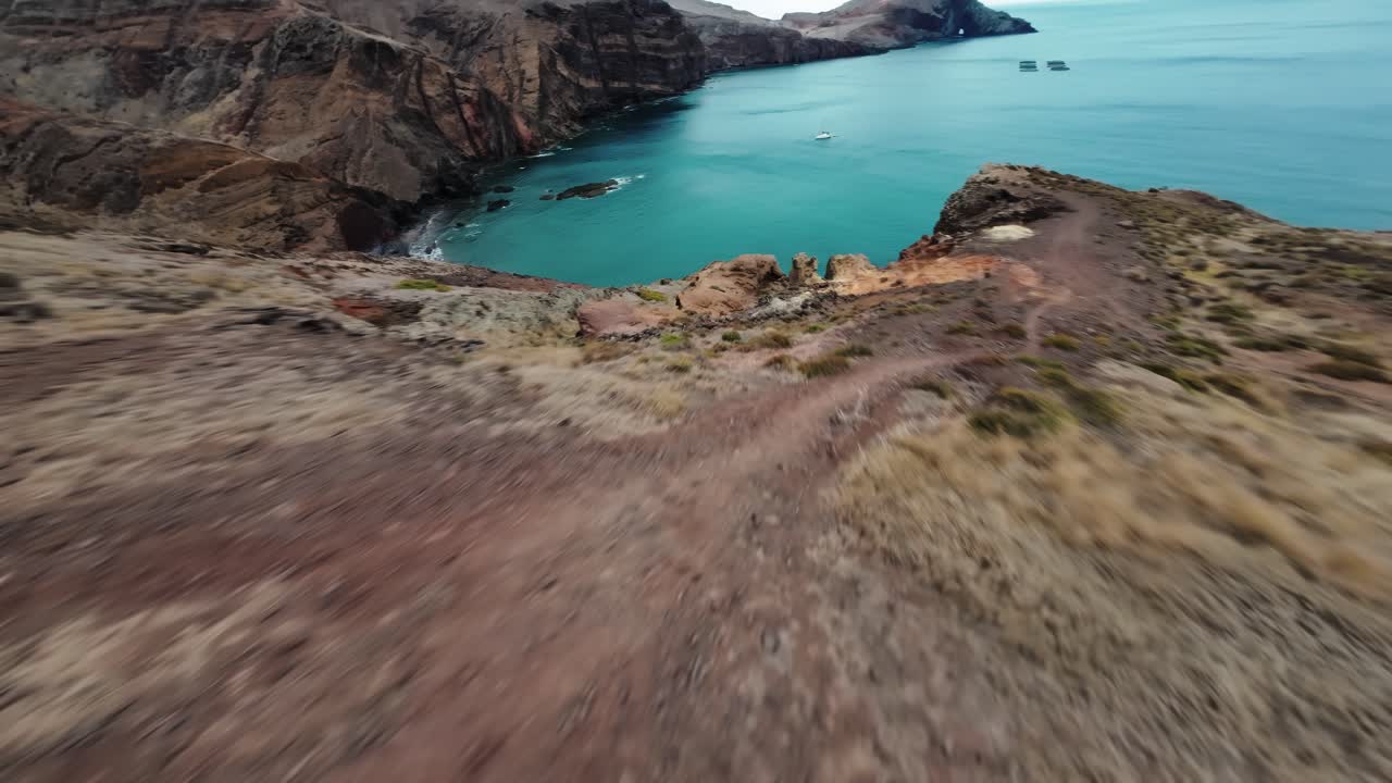 FPV shot diving above dramatic cliffs and turquoise waters at Ponta de São Lourenço, Madeira, Portugal
