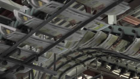 newspapers flow along an assembly line in a newspaper factory 3