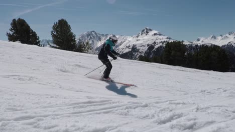 Slomotion-skiing-with-professional-athlete-in-perfect-mountain-panorama