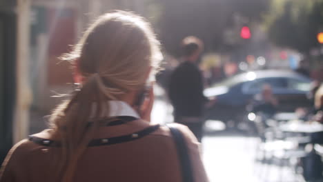 Busy-urban-lifestyle-Woman-with-mobile-in-lively-street